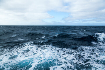 Ocean water background with foam. Ocean water splash. Not a calm 