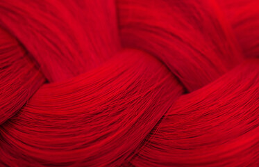 Red-haired Beautifully laid braid carroty curls.Female long red hair close-up as a background. Hair...