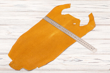 natural colored brown red sand rays leather on the wooden table	
