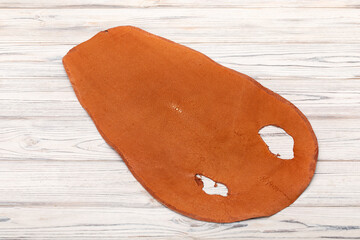 natural colored brown red sand rays leather on the wooden table	
