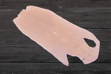 natural colored pink rays leather on the wooden table	

