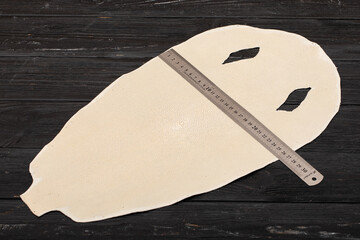 natural colored beige sand rays leather on the wooden table	