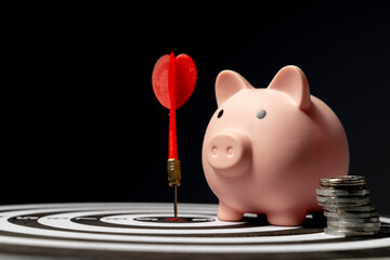 piggy bank on dartboard concept of saving money with a goal. set targets for saving money