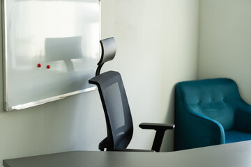Cropped shot of portable office desk with computer devices, supplies and decorations on white table.