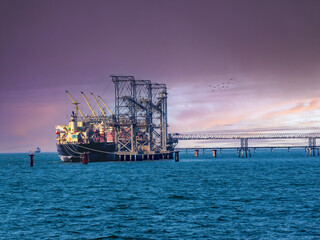 Bulk Vessel alongside at thailand port and loading bulk cargo by shiploader.