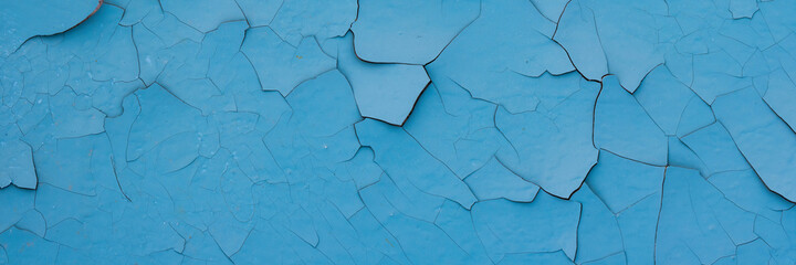 Peeling paint on the wall. Panorama of a concrete wall with old cracked flaking paint. Weathered...