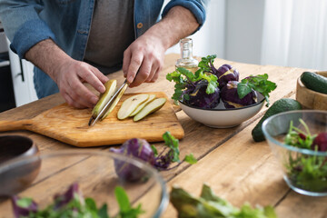 Cooking healthy and tasty breakfast or lunch. Male hands preparing vegetarian food at home kitchen