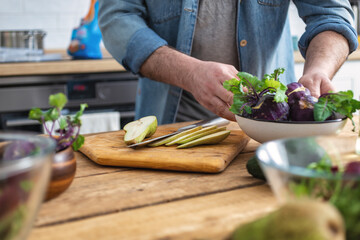 Male hands preparing vegetarian food at home kitchen. Cooking healthy and tasty breakfast or lunch