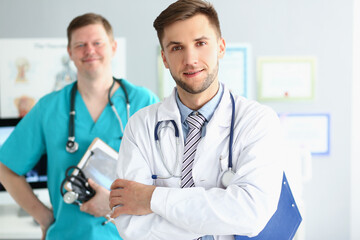 Fototapeta premium Medical male workers in uniform with stethoscopes, medical help, emergency team