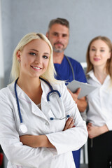 Young smiling woman start full working day in clinic after internship