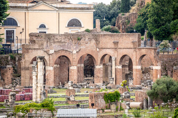 Naklejka premium Ruins of an ancient city in Italy, old buildings in the open air, streets of ancient cities. Remains of old buildings, columns and statues on the streets of the city of Rome.
