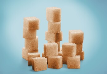 Pile of brown granulated sugar and sugar cubes on the desk