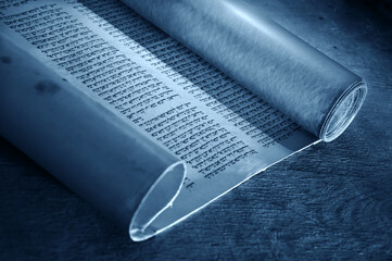 Fototapeta premium Ancient scroll lit by candlelight
