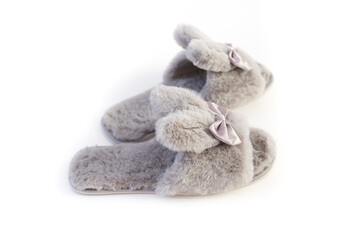 Slippers in the shape of a bunny with ears isolated on a white background, women's or children's indoor clothing, cute fluffy fur slippers home