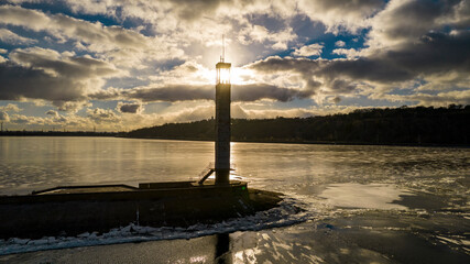 Aerial view of a lighthouse on a frozen lake
