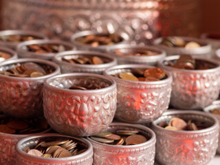 Silver bowl that holds coins according to Buddhist beliefs at Thungsaliam temple, Sukhothai, Thailand.