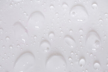 Water drops on glass on a white background. Water drop texture as background. Freshness after the rain. Ecology of wet clean nature. steam in the shower