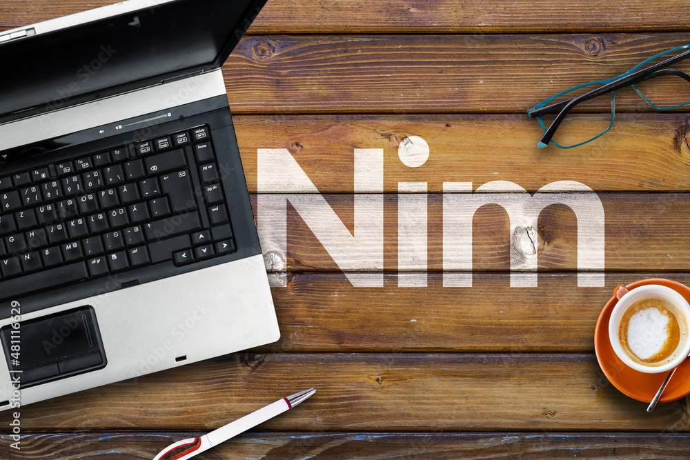 Aufkleber nim programming language. word nim on wooden desk and laptop