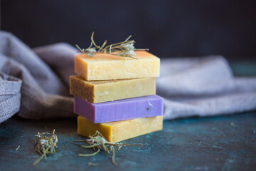 Set of different aromatic handmade natural soaps with lavender blanches. Natural cosmetics assortment. Side view close up