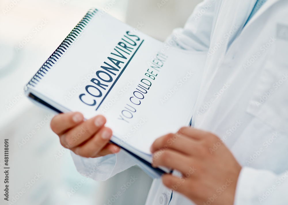 Poster Arm yourself with knowledge. Shot of a scientist holding a notepad with CORONAVIRUS-YOU COULD BE NEXT on it in a laboratory.