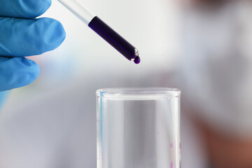 Chemist conducts analysis of water samples versions of reagents using chemical manufacturing
