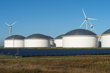 Oil storage tanks, solar panels and  wind turbines.