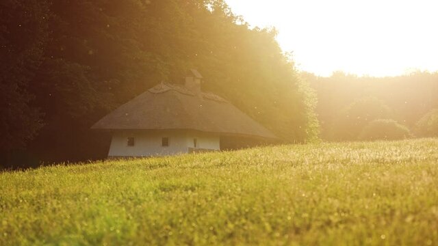 Old house in the countryside in the rays of the evening sun