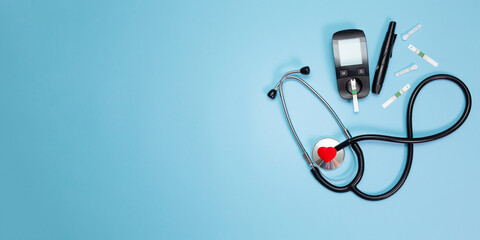 Diabetes equipment, glucose level blood test on blue background with copy space. Diabetic items to...