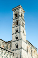 Fototapeta na wymiar The marbled bell tower of Prato cathedral, or Cathedral of Saint Stephen, in Romanesque style, Duomo square, Prato city, Tuscan region, Italy
