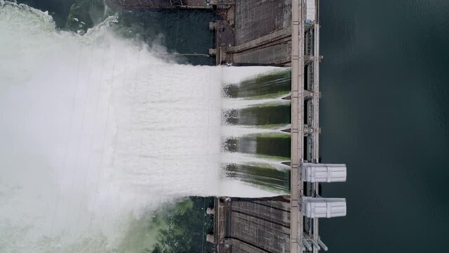 Aerial top down view of water discharge at hydroelectric power plant