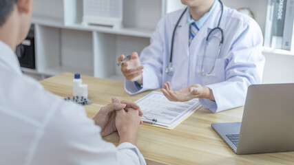Male doctor made a diagnosis on a male patient and gave advice on treatment methods in the hospital examination room, Helping patients with medical advice, Health care counseling.