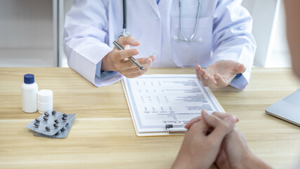 Male doctor made a diagnosis on a male patient and gave advice on treatment methods in the hospital examination room, Helping patients with medical advice, Health care counseling.