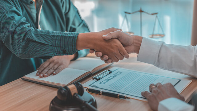 Businessman shaking hands with a lawyer or judge After signing the contract and the agreement is complete, Approval of an agreement between business and law, End of the legal case.