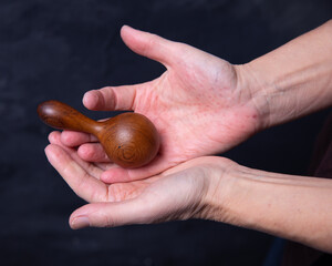 Wooden massager, manual roller massage in the hands of a massage therapist