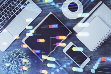 Double exposure of technology theme drawing over work table desktop. Top view. Global data analysis concept.