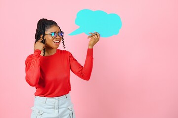 I Think. Pensive afro woman looking at blank speech bubble, touching her chin, copyspace, pink studio wall