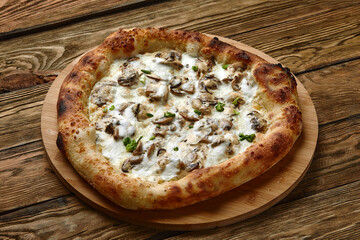 Appetizing pizza with mushrooms on a wooden tray