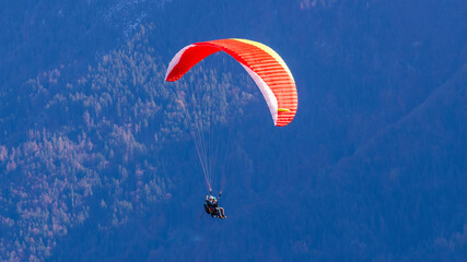 Paragliding over Swiss lake and mountains in Interlaken in Switzerland