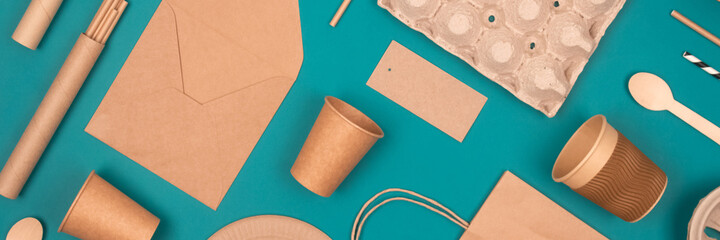 Banner. Flat lay with eco-friendly tableware and sustainable packaging. Kraft paper food packaging...