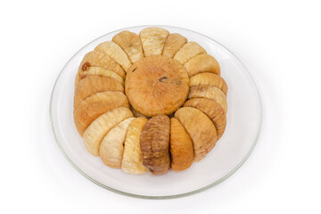 Dried figs laid out in a circle on glass saucer