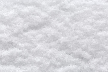 Texture of newly-fallen fluffy snow layer on vertical surface