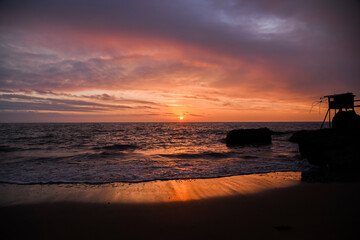 .French oceanfront landscape, oceanfront fishing houses in France during sunset.