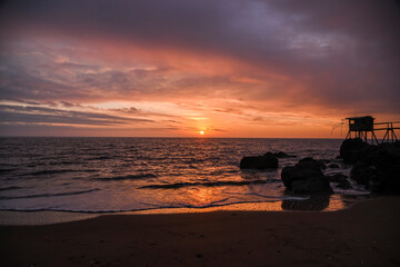 .French oceanfront landscape, oceanfront fishing houses in France during sunset.