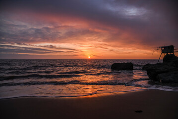 .French oceanfront landscape, oceanfront fishing houses in France during sunset.