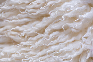White animal fur. Weasel or cat hair. Fur clothes, white fur coat close up. Eco-wool, eco-leather artificial fur.