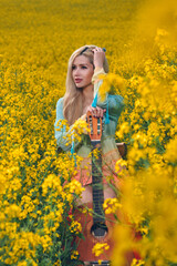 sexy woman in the field with a guitar. concept freedom, inspiration, relaxation