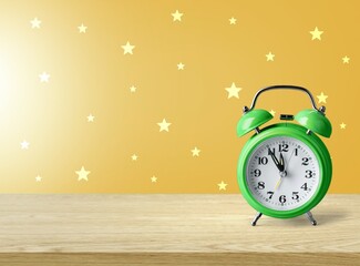 Alarm clock on yellow background. Christmas and Happy new year concept.