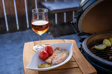 grilling salmon on a ceramic grill with charcoal in the garden at a winter day in the outdoor