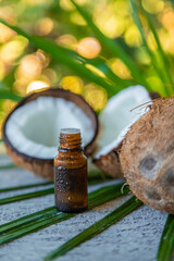 Coconut fruits and coconut oil isolated on table background