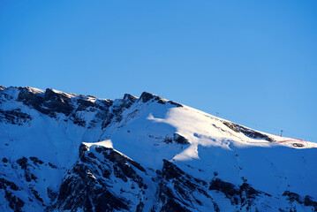 Swiss Alps with downhill slope of famous Lauberhorn Ski Race on a sunny winter morning. Photo taken...